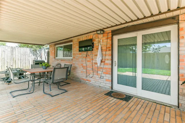 a patio with table and chairs