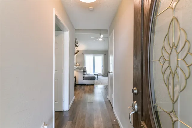 a view of a hallway with couch and wooden floor