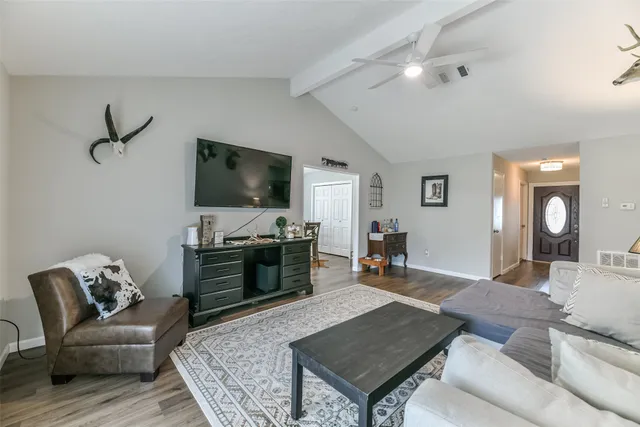 a living room with furniture and a flat screen tv