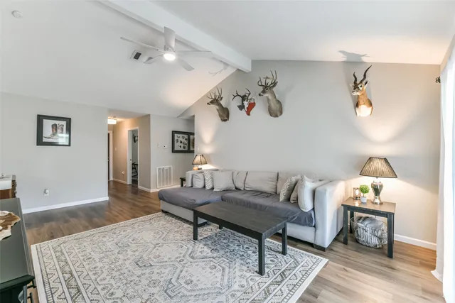 a living room with furniture and wooden floor