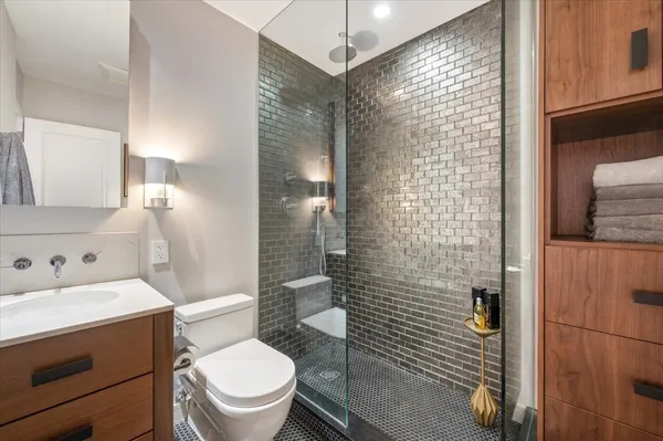 a bathroom with a toilet a sink and shower