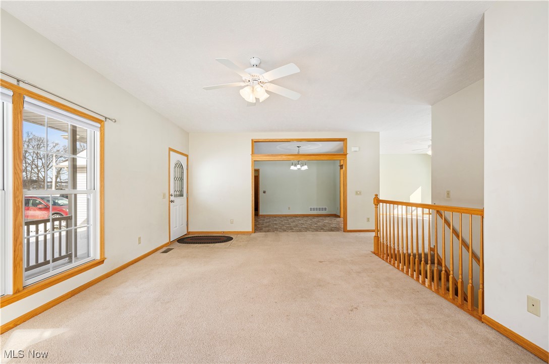706 Watson Road Deerfield, OH 44411 - Photo 5 of 36 Carpeted living room with ceiling fan with notable chandelier