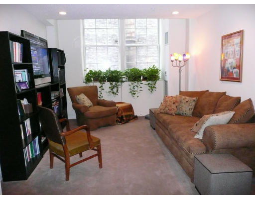 200 Market Street, Unit 3305 Lowell, MA 01852 - Photo 1 of 7 a living room with furniture and a large window
