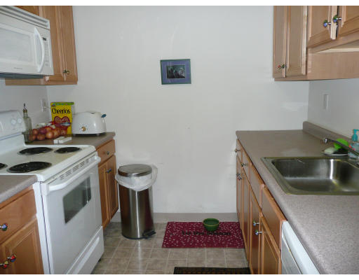 200 Market Street, Unit 3305 Lowell, MA 01852 - Photo 4 of 7 a kitchen with a sink a stove and cabinets