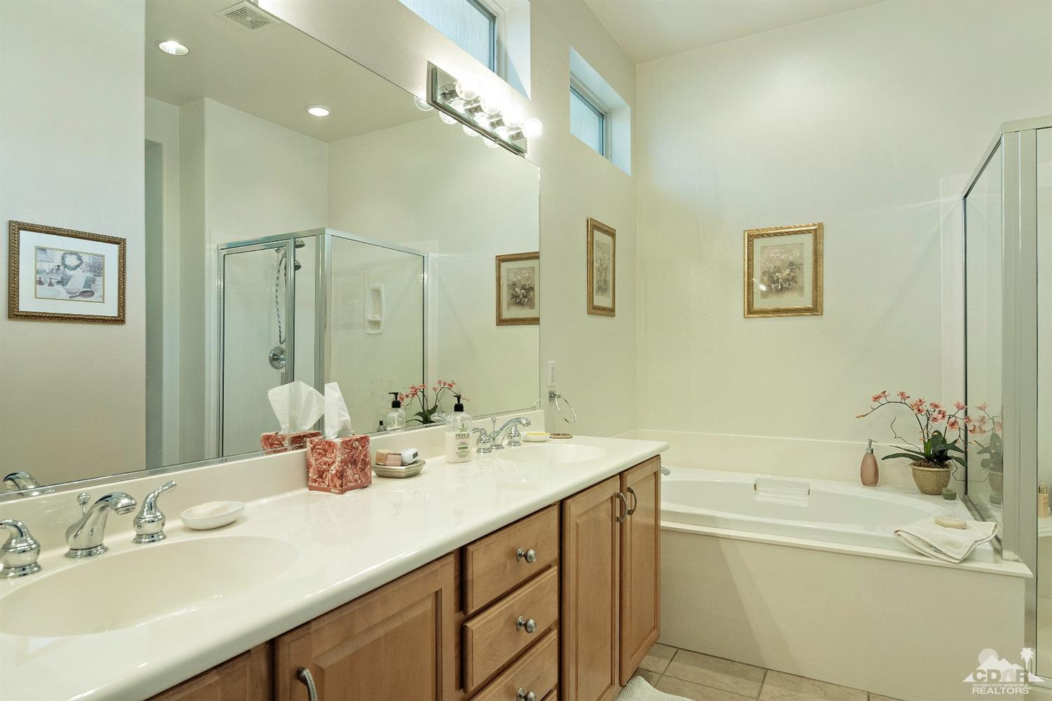 80561 Knightswood Road Indio, CA 92201 - Photo 11 of 25 a bathroom with a tub sink and mirror