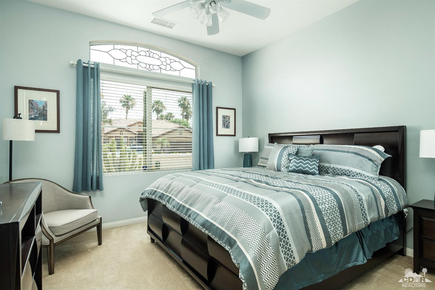 80561 Knightswood Road Indio, CA 92201 - Photo 12 of 25 a bedroom with a bed chair and a window