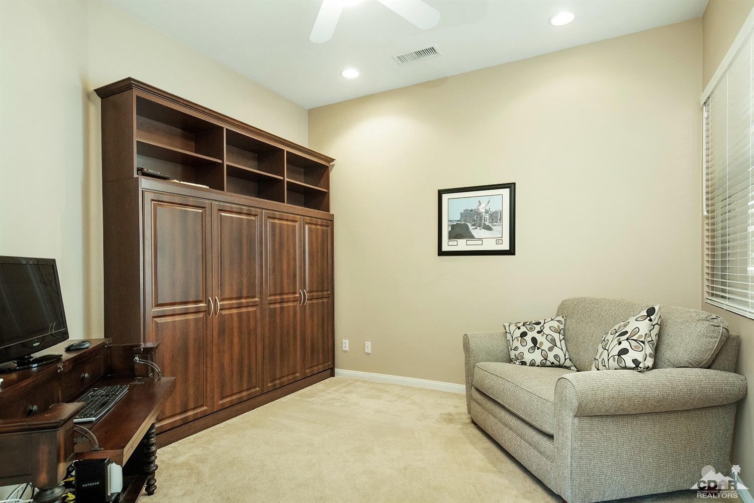 80561 Knightswood Road Indio, CA 92201 - Photo 14 of 25 a living room with furniture and a flat screen tv