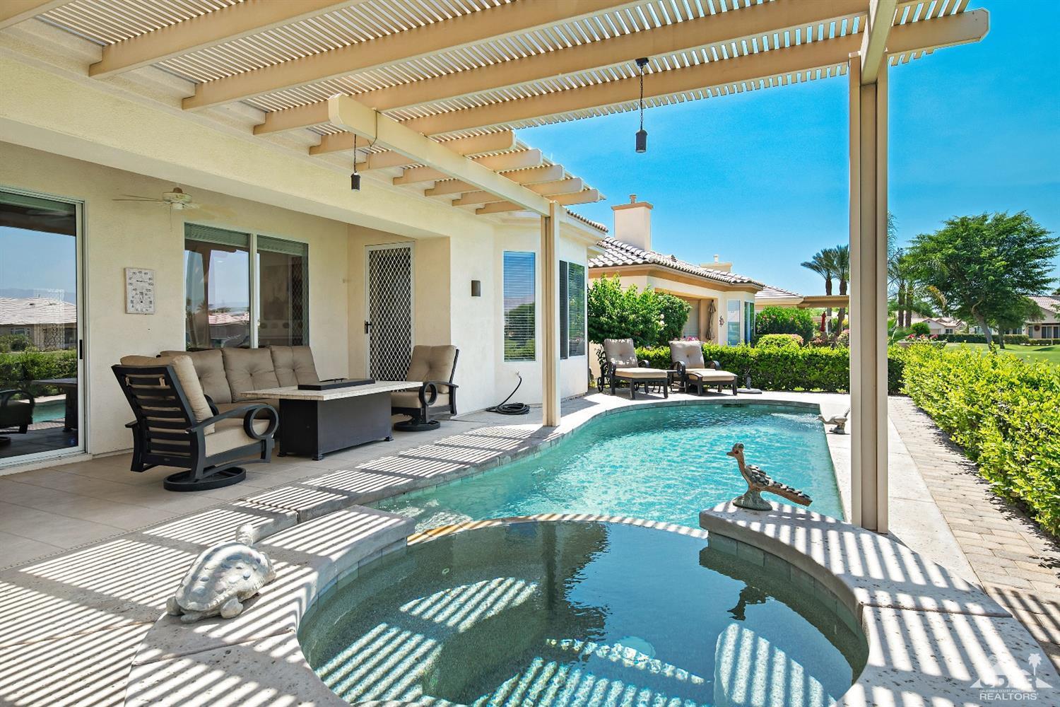 80561 Knightswood Road Indio, CA 92201 - Photo 19 of 25 a view of a patio with couches table chairs and potted plants