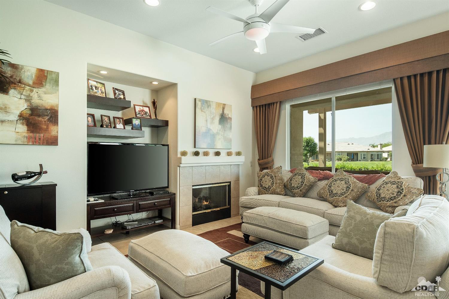 80561 Knightswood Road Indio, CA 92201 - Photo 3 of 25 a living room with furniture a large window and a flat screen tv