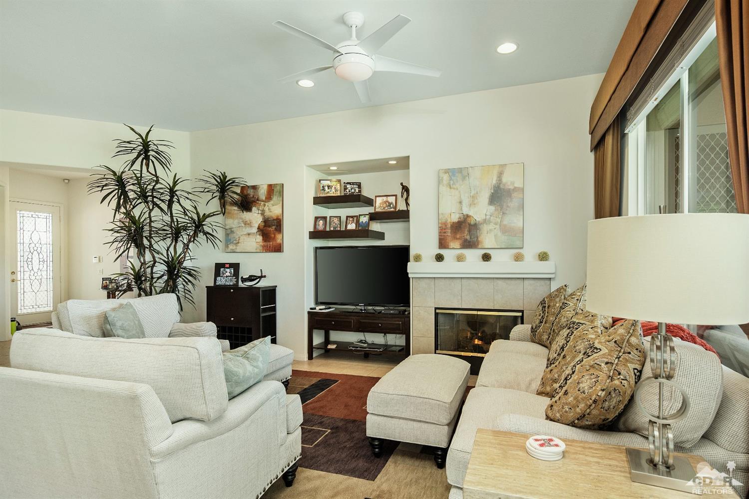 80561 Knightswood Road Indio, CA 92201 - Photo 4 of 25 a living room with furniture fireplace and a flat screen tv