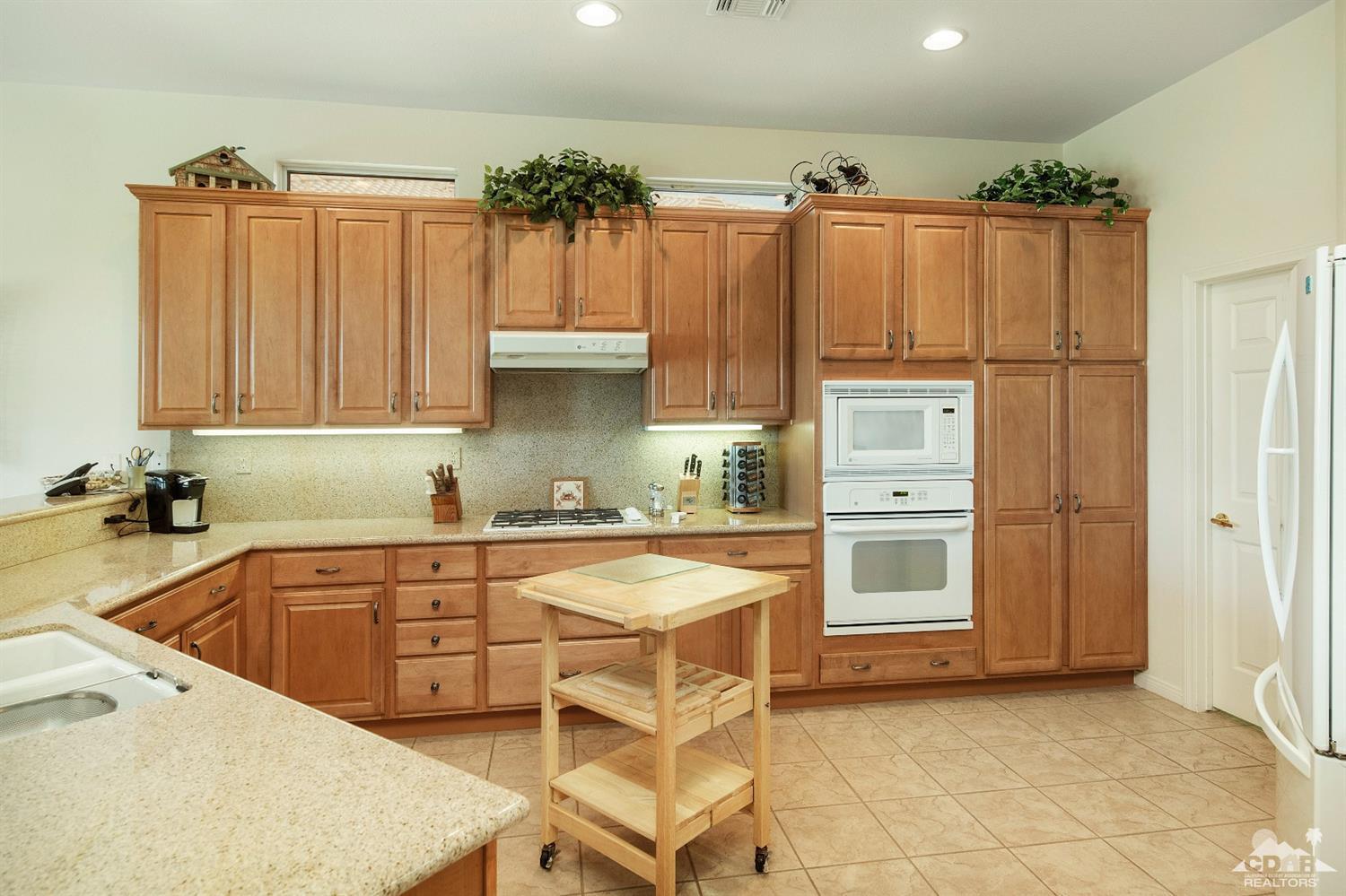 80561 Knightswood Road Indio, CA 92201 - Photo 7 of 25 a kitchen with stainless steel appliances a refrigerator and a sink