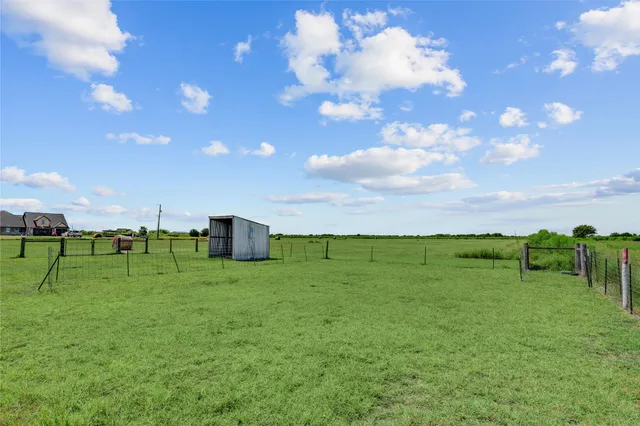 a green field with lots of trees in it