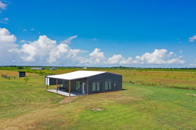 a view of a house with swimming pool and porch