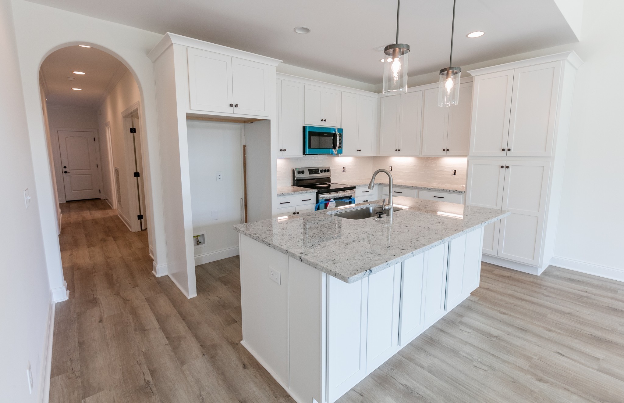 428 West Foxrun Springfield, TN 37172 - Photo 3 of 5 an open kitchen with granite countertop kitchen island wooden floor center island stainless steel appliances and cabinets