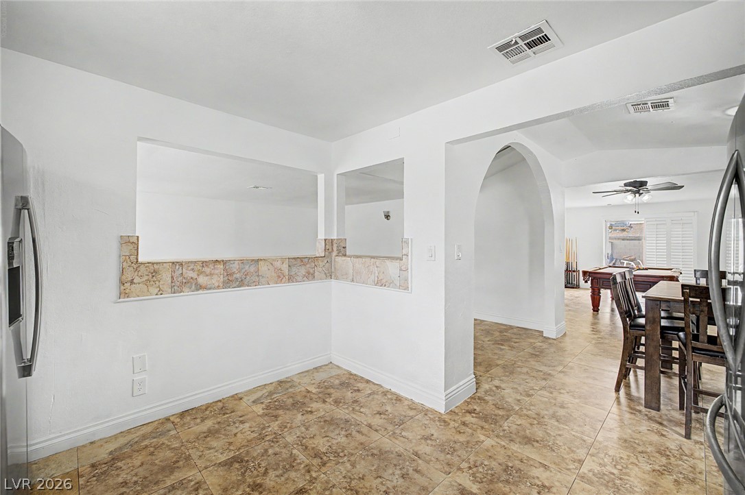 5357 Indian Wells Road Las Vegas, NV 89110 - Photo 12 of 39 A well-appointed kitchen nook featuring an elegant pass-through window to the adjacent living space.