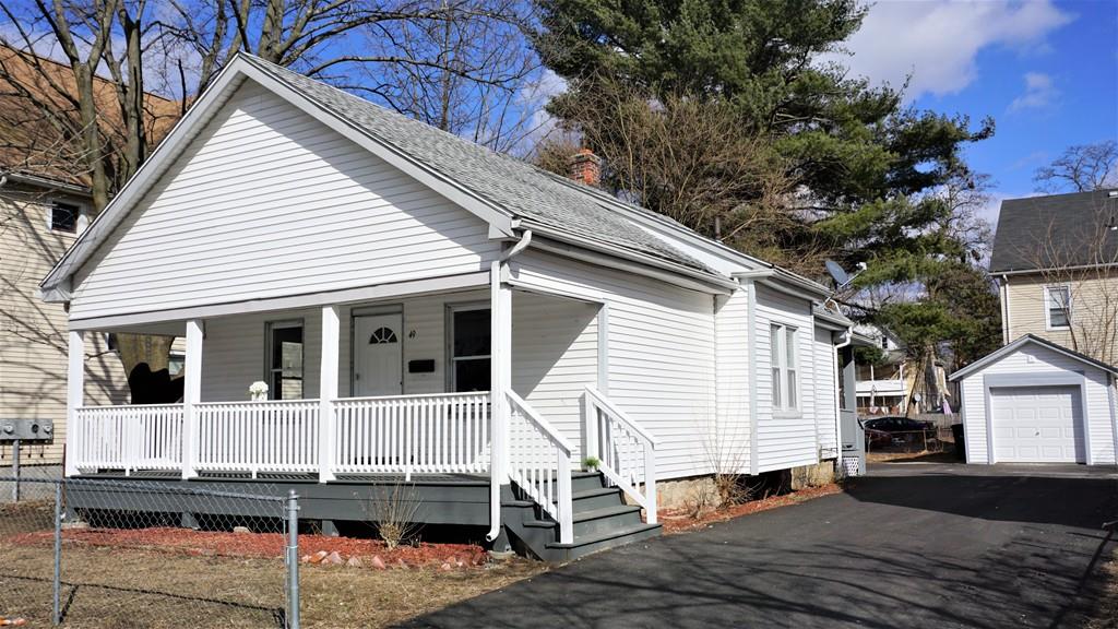 49 Ranney Street Springfield, MA 01108 - Photo 1 of 29 a view of a white house with a small yard and wooden fence
