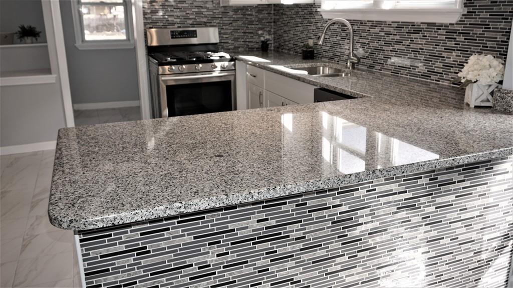 49 Ranney Street Springfield, MA 01108 - Photo 12 of 29 a kitchen with granite countertop a sink and a stove