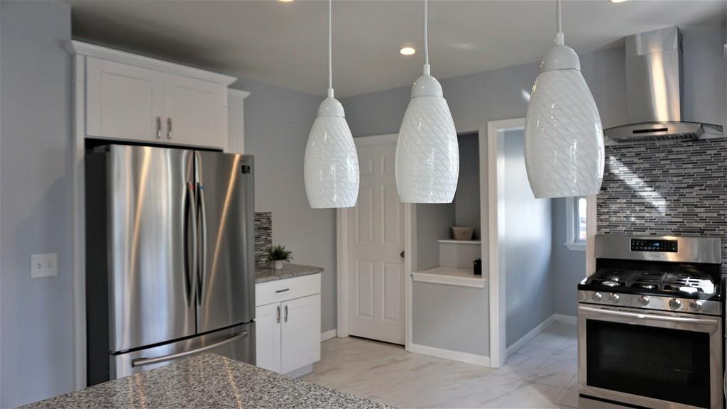49 Ranney Street Springfield, MA 01108 - Photo 13 of 29 a kitchen with stainless steel appliances a refrigerator sink and stove