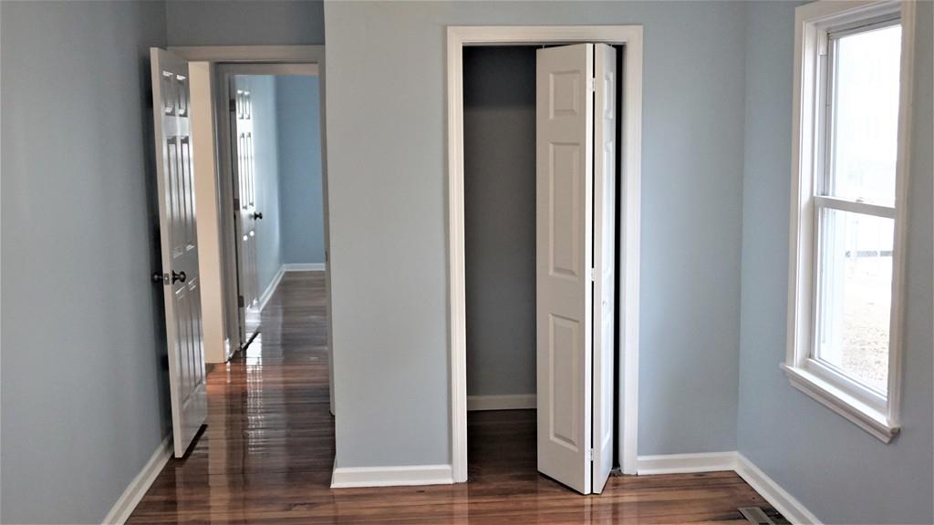 49 Ranney Street Springfield, MA 01108 - Photo 22 of 29 a view of a hallway with wooden floor and windows