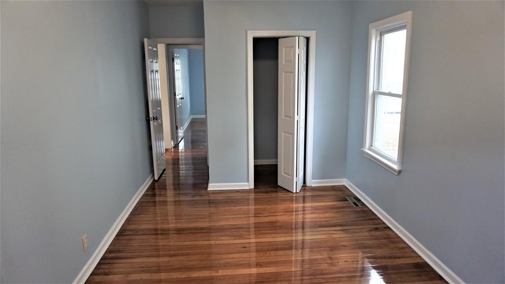49 Ranney Street Springfield, MA 01108 - Photo 23 of 29 a view of a hallway with wooden floor and staircase