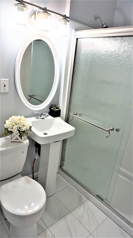 49 Ranney Street Springfield, MA 01108 - Photo 25 of 29 a bathroom with a toilet and a mirror
