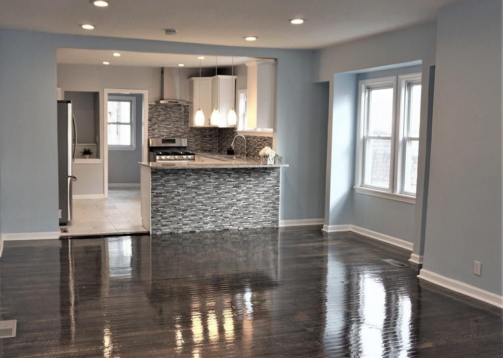 49 Ranney Street Springfield, MA 01108 - Photo 3 of 29 a bathroom with a granite countertop sink and a large mirror