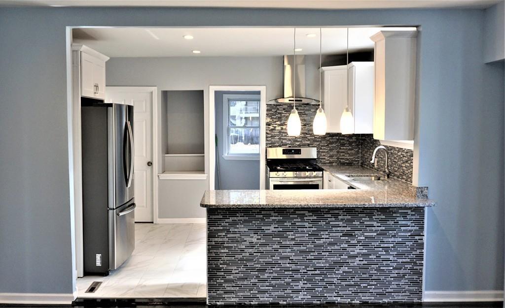49 Ranney Street Springfield, MA 01108 - Photo 6 of 29 a kitchen with stainless steel appliances granite countertop a refrigerator and a stove