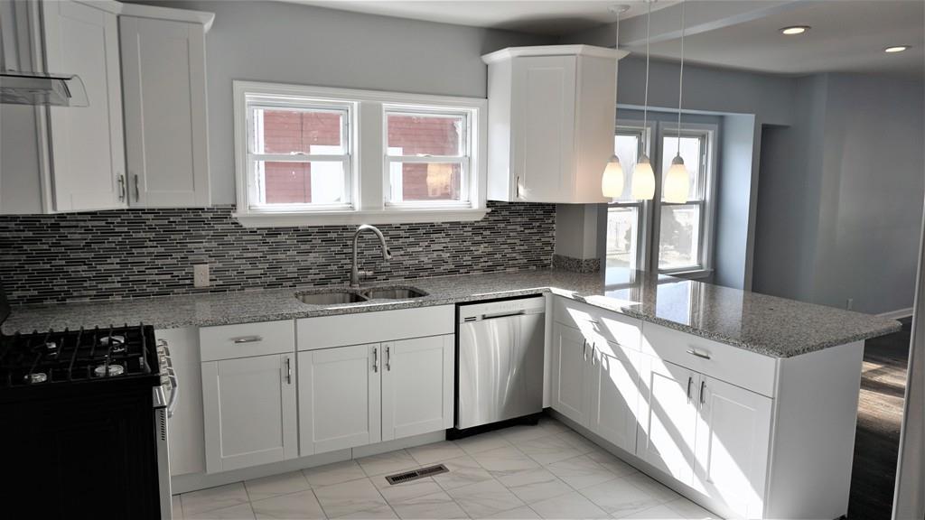 49 Ranney Street Springfield, MA 01108 - Photo 7 of 29 a kitchen with granite countertop a sink and a stove