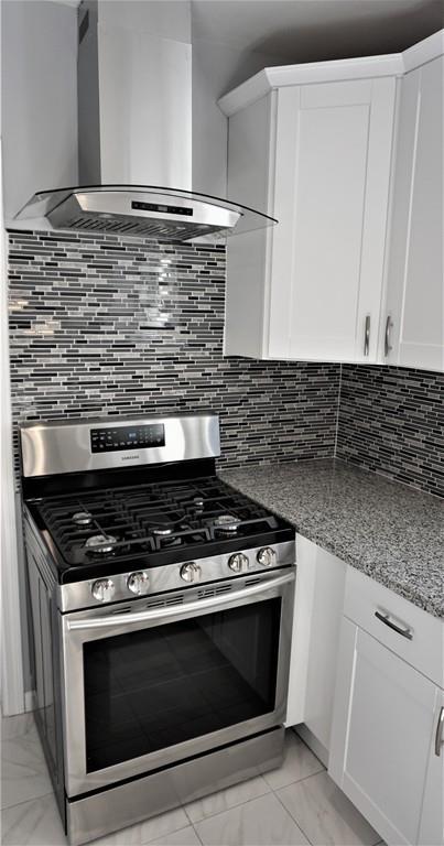 49 Ranney Street Springfield, MA 01108 - Photo 9 of 29 a stove top oven sitting inside of a kitchen