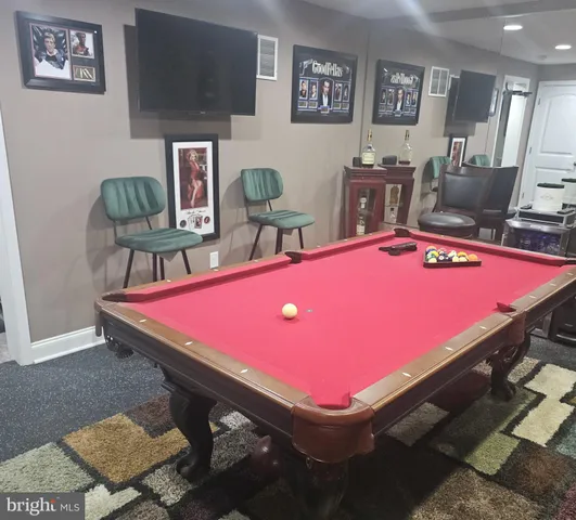 a room with pool table and wall paintings