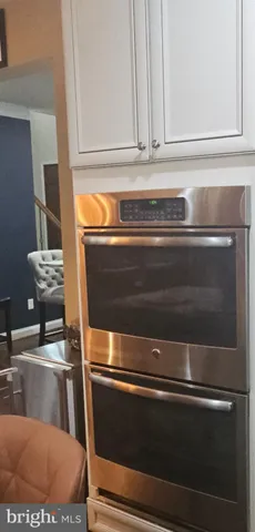 a sink with white cabinets