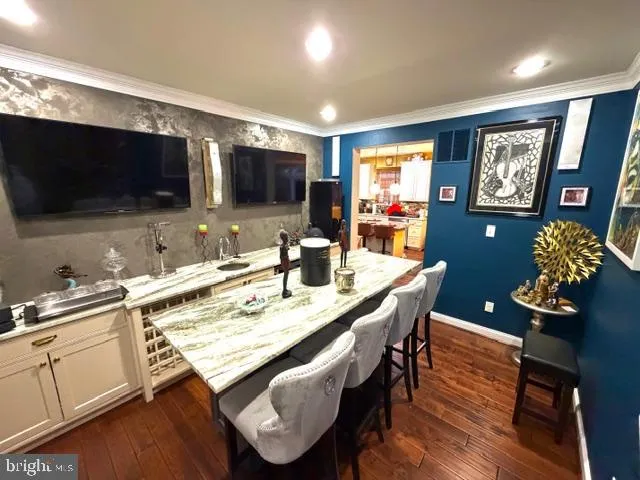 a kitchen with stainless steel appliances granite countertop a stove a sink a microwave a dining table and chairs