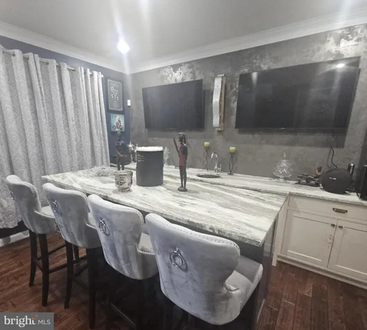a kitchen with a table chairs and a sink
