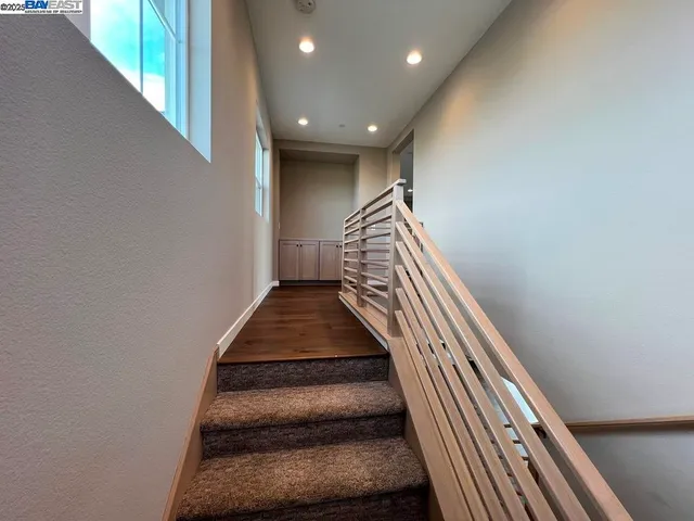 an empty room with wooden floor and entrance