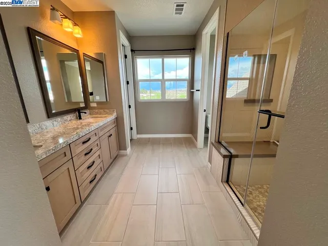 a kitchen with a stove sink and cabinets