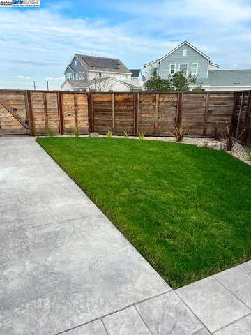 a view of residential houses with cars parked