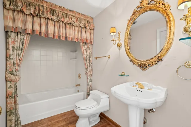 a bathroom with a sink mirror toilet and bathtub