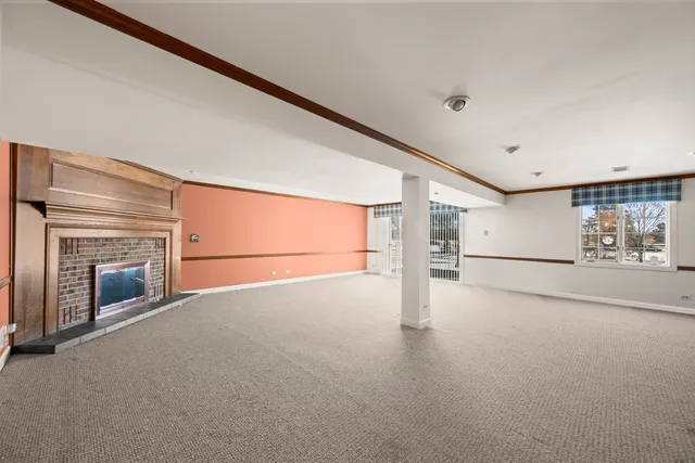 a view of a livingroom with an empty space and a fireplace