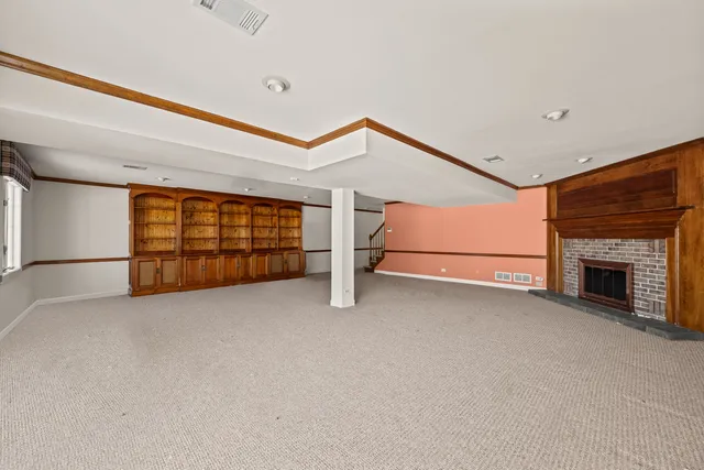 a view of an empty room with a fireplace