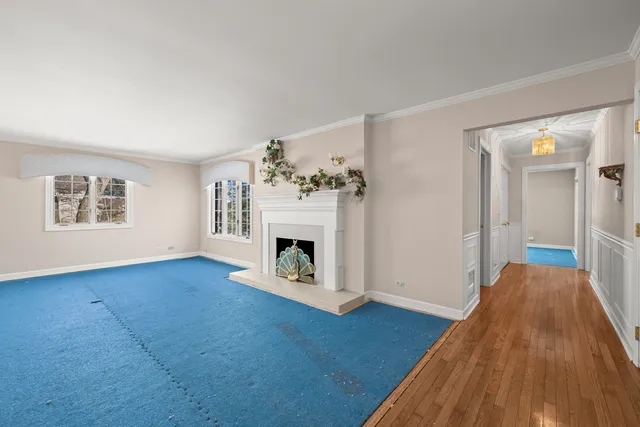 a view of a livingroom with a fireplace wooden floor and a fireplace