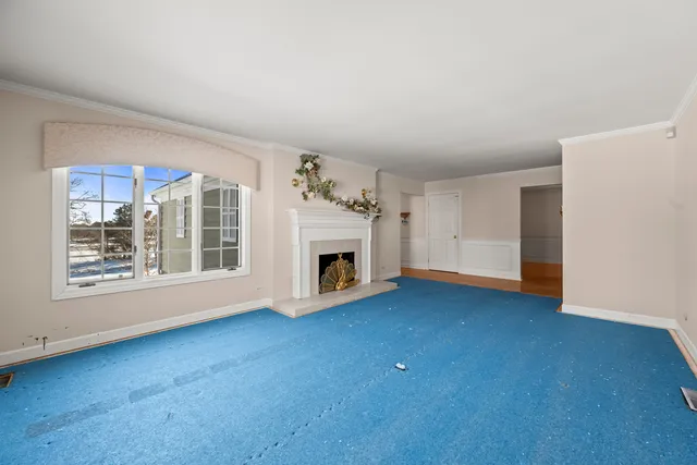 a view of empty room with a fireplace