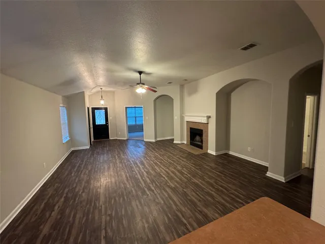 wooden floor in an empty room with a fireplace