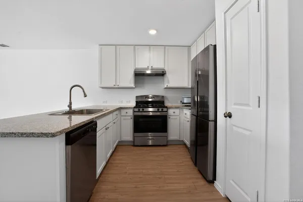 a kitchen with a sink and a refrigerator