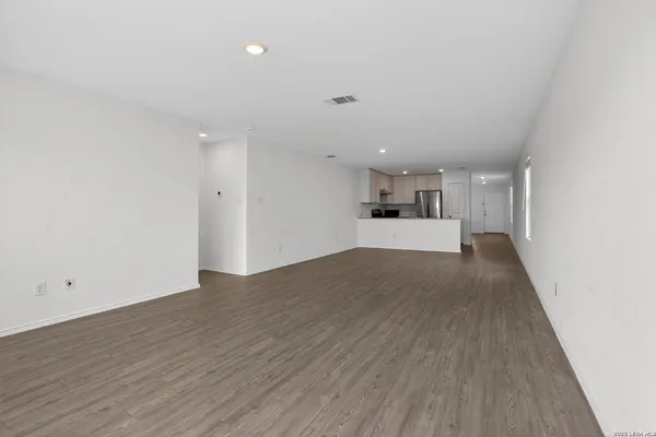 a view of a kitchen with a sink and a refrigerator