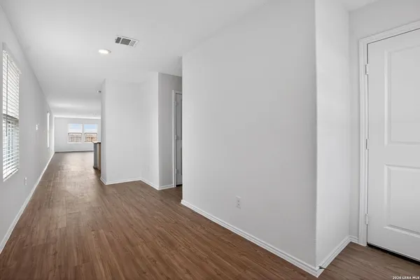 a view of a hallway with wooden floor