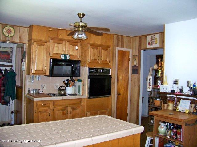 362 Camelback Road Tannersville, PA 18372 - Photo 3 of 13 a bedroom with a bed and a chandelier