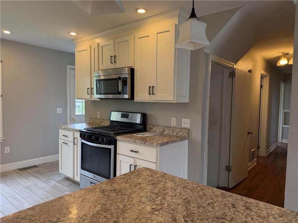 1146 Franklin Road Jackson Center, PA 16133 - Photo 6 of 19 a kitchen with stainless steel appliances granite countertop a stove and a sink