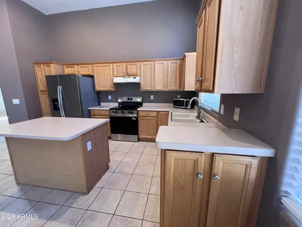 a kitchen with a sink a counter top space and cabinets