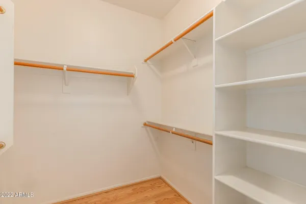 a view of walk in closet with empty racks