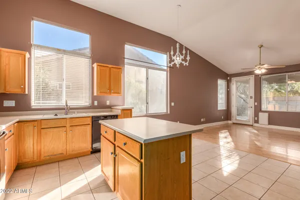 a kitchen with stainless steel appliances granite countertop a sink and a stove